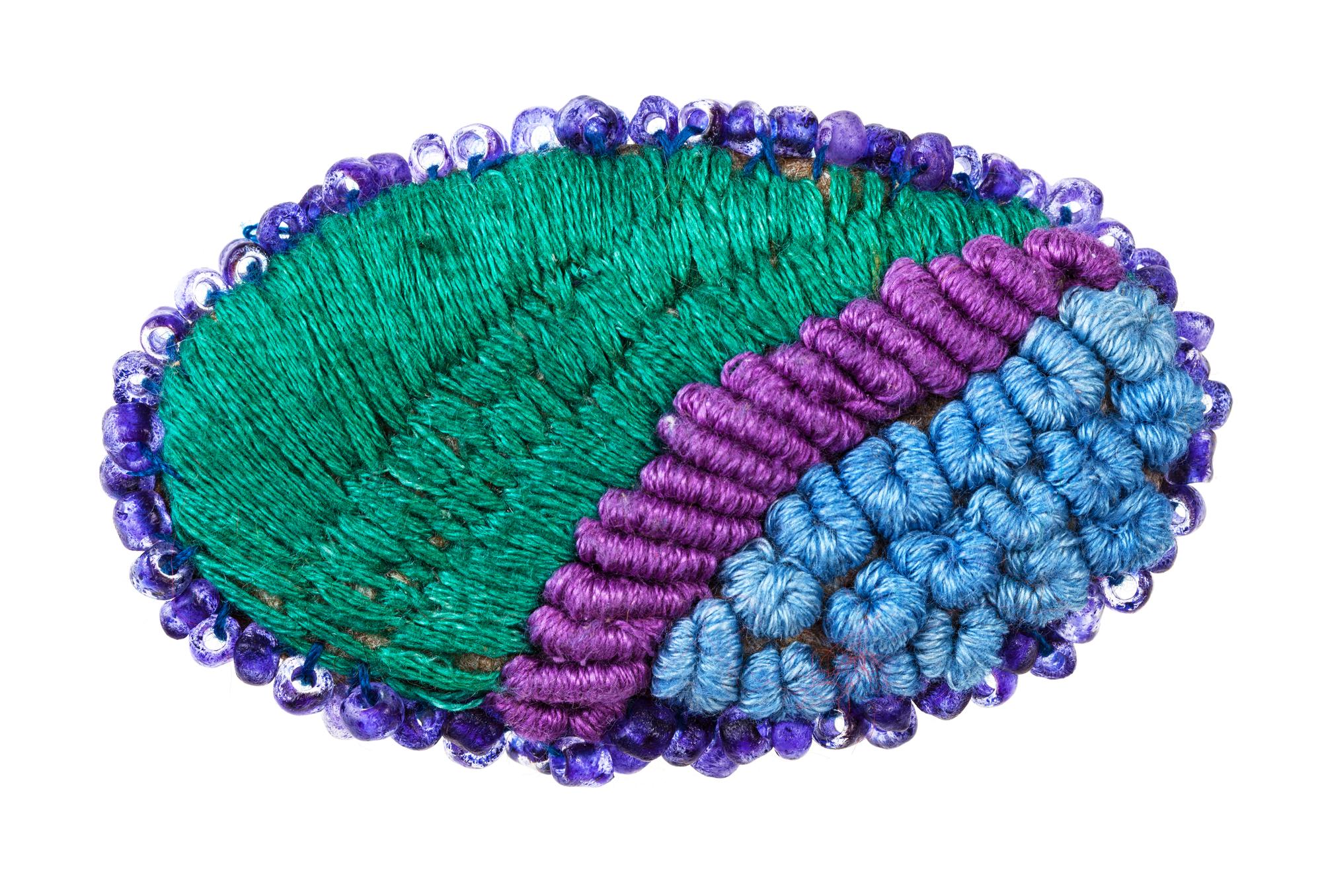 closeup embroidered patch with metallic thread and beads