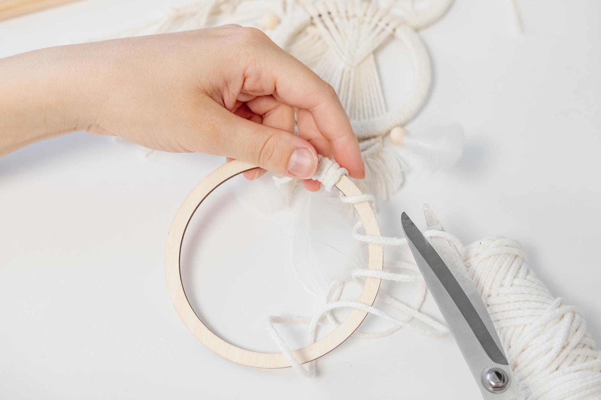 hand working on embroidered hoop in studio
